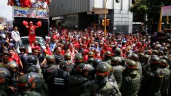 Supporters of Venezuela's President Nicolas Maduro shout slogans as they gather outside the National Assembly building during a session in Caracas, Venezuela