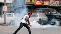 A protester throws stones at police during clashes in Rawalpindi, Pakistan October 28, 2016.
