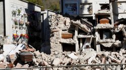 Coffins are seen in the collapsed cemetery of the village of Campi near Norcia, following an earthquake in central Italy,