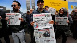 Supporters of Cumhuriyet newspaper, an opposition secularist daily, hold today's copies during a protest in front of its headquarters in Istanbul, Turkey,