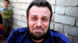 Wheelchair-bound man, Abbas Ali, 42, cries with relief after escaping with his wife and four children from the Islamic State-controlled village of Abu Jarboa,