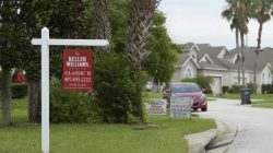 For Sale signs stand in front of houses in a neighborhood where many British people have purchased homes in Davenport, Florida, U.S.,