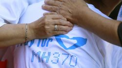 Family members of passengers onboard the missing Malaysia Airlines Flight MH370 comfort a crying woman as they gather to pray at Yonghegong Lama Temple in Beijing September 8, 2014, on the six-month anniversary of the disappearance of the plane.