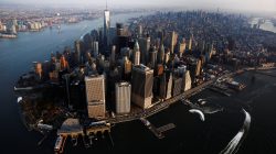 The rising sun lights One World Trade as it stands over the Manhattan borough of New York.