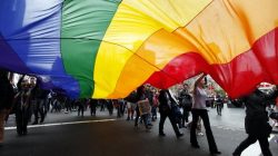 Gay rights activists hold a rainbow flag during a rally to support same-sex marriage in central Sydney August