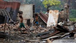 Children recycle goods from the ruins of a market which was set on fire at a Rohingya village outside Maugndaw in Rakhine state, Myanmar,
