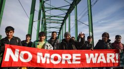 Refugees and migrants cross the Old Sava Bridge heading in the direction of the Croatian border, in Belgrade, Serbia