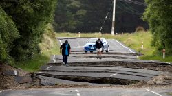 Local residents Chris and Viv Young look at damage caused by an earthquake along State Highway One near the town of Ward, south of Blenheim on New Zealand's South Island,