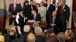 Obama signs Affordable Care Act AKA Obamacare