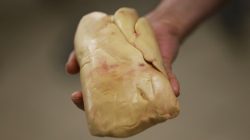 Employee holds a duck liver in at a poultry farm in Doazit, Southwestern France,