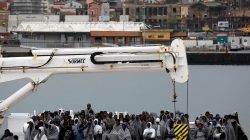 Migrants wait to disembark from Italian Coast Guard patrol vessel Diciotti in the Sicilian harbour of Catania, Italy,