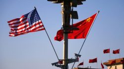 U.S. (L) and Chinese national flags flutter on a light post at the Tiananmen Square ahead of a welcoming ceremony for U.S. President Barack Obama, in Beijing,
