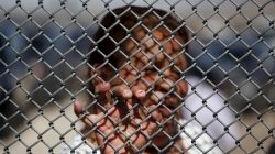 A Mexican migrant talks to a family member through the border fence between Ciudad Juarez and El Paso, United States, after a bi-national Mass in support of migrants in Ciudad Juarez, Mexico,