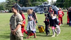 Evacuees formerly stranded in the earthquake-affected town of Kaikoura walk away from the New Zealand Air Force helicopter that brought them to the town of Woodend, near Christchurch, New Zealand,
