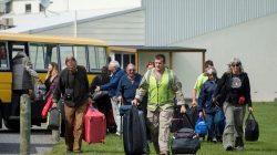 Royal New Zealand Air Force personnel lead those stranded by an earthquake to an NH90 helicopter to evacuate them from Kaikoura on the South Island of New Zealand