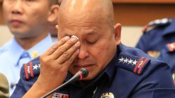 Philippine National Police chief Ronald Dela Rosa wipes his tears after answering questions, during a joint hearing session of the committee on public order and dangerous drugs and the committee on justice and human rights, at Senate headquarters in Pasay city, metro Manila, Philippines