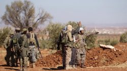 Rebel fighters gather during their advance towards the Islamic State-held city of al-Bab, northern Syria