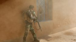An Iraqi soldier searches a house during clashes with Islamic State fighters in Al-Qasar, southeast of Mosul.