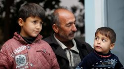 Aiden Jassim's children sit next to their uncle Abdul Ilah Jassim during an interview with Reuters in Fadiliyah, Iraq,