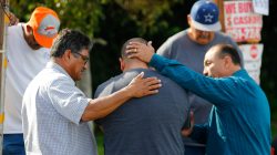 Neighbours comfort Jose Gonzales (centre), who was prevented from returning to his wife and his home at the scene of the investigation around the area of the SUV vehicle where two suspects were shot by police following a mass shooting in San Bernardino, California December 3, 2015.