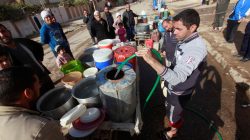 Iraqi people collect water in Mosul, Iraq,