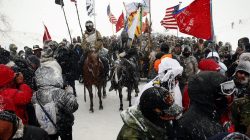 Veterans march with activists near Backwater Bridge just outside the Oceti Sakowin camp during a snow fall as "water protectors" continue to demonstrate against plans to pass the Dakota Access pipeline