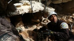 Civil Defence members look for survivors under rubble of damaged buildings after air strikes on the northern neighbourhood of Idlib city, Syria