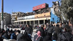 People, who were evacuated from the eastern districts of Aleppo, wait with their belongings in a government held area of Aleppo, Syria,