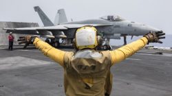 A U.S. Navy crewman directs an F/A-18E Super Hornet fighter jet on the flight deck of the aircraft carrier USS Harry S. Truman in the Mediterranean Sea in a photo released by the US Navy June 3, 2016. U U.S. Navy/Mass Communication Specialist 3rd Class