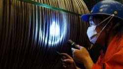 A worker verifies a product at a steel factory in Dalian, Liaoning province, China