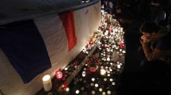 A man pays his respects during a gathering at the Place de la Republique in Paris, France, November 13, 2016, after ceremonies held for the victims of last year's Paris attacks which targeted the Bataclan concert hall as well as a series of bars and killed 130 people.