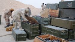 Islamic State fighters search weapon boxes in a Russian base in what is said to be Palmyra,