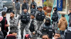 Jordanian policemen leave after ending security operations in the vicinity of Karak Castle, where armed gunmen carried out an attack yesterday, in the city of Karak, Jordan