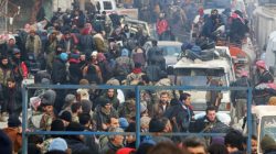 FILE PHOTO - Rebel fighters and civilians gather as they wait to be evacuated from a rebel-held sector of eastern Aleppo, Syria December