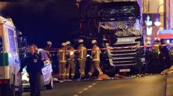 Police and emergency workers stand next to a crashed truck at the site of an accident at a Christmas market on Breitscheidplatz square near the fashionable Kurfuerstendamm avenue in the west of Berlin, Germany, December 19, 2016.