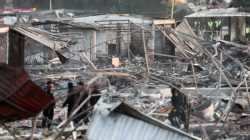 Police officers walk amongst the wreckage of houses destroyed in an explosion at the San Pablito fireworks market outside the Mexican capital on Tuesday, in Tultepec, Mexico,