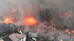 A fire engulfs houses and stores, near JR Itoigawa Station, in Itoigawa, Niigata Prefecture, Japan, in this photo taken by Kyodo