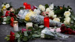 Flowers are seen near the scene where a truck ploughed into a crowded Christmas market in the German capital last night in Berlin, Germany,