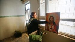 A Christian woman inspects a home in the town of Bartella east of Mosul, Iraq, after it was liberated from Islamic State militants