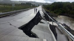 A damaged road is seen after a quake at Tarahuin, on Chiloe island, southern Chile