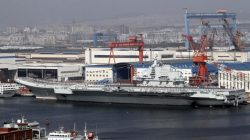 A general view shows navy soldiers standing on China's first aircraft carrier "Liaoning" as it is berthed in a port in Dalian, northeast China's Liaoning province,