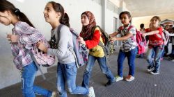 Syrian refugee children queue as they head towards their classroom at a school in Mount Lebanon,
