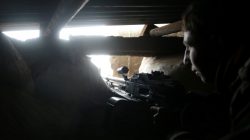 A rebel fighter stands on a lookout point with his weapon on the forth day of the truce, on al-Rayhan village front near the rebel held besieged city of Douma, in the eastern Damascus suburb of Ghouta, Syria