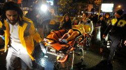 An injured woman is carried to an ambulance from a nightclub where a gun attack took place during a New Year party in Istanbul, Turkey.