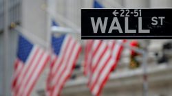A street sign for Wall Street is seen outside the New York Stock Exchange (NYSE) in Manhattan, New York City, U.S. December 28, 201
