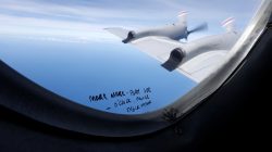 Handwritten notes on how a crew member should report the sighting of debris in the southern Indian Ocean is pictured on a window aboard a Royal New Zealand Air Force P-3K2 Orion aircraft searching for missing Malaysian Airlines flight MH370