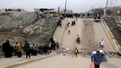 Displaced people, who fled Islamic State militants, cross the bridge in Al-Muthanna neighborhood of Mosul, Iraq,