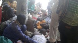 Injured people are comforted at the site after a bombing attack of an internally displaced persons camp in Rann, Nigeria