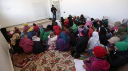 schoolchildren sit on mats as they return to school in Aleppo after Islamic State driven out