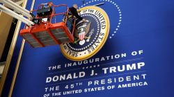 workers install the presidential seal for Trump's inauguration